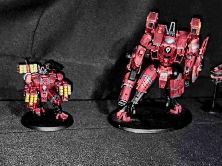 Painted T’au miniatures from a Forge Without Limits hobby collection.