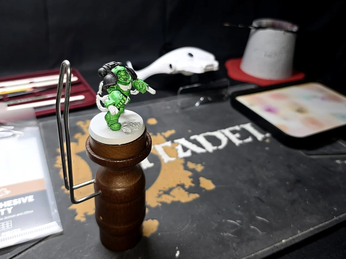 Miniature held securely during painting using practical hobby support equipment.